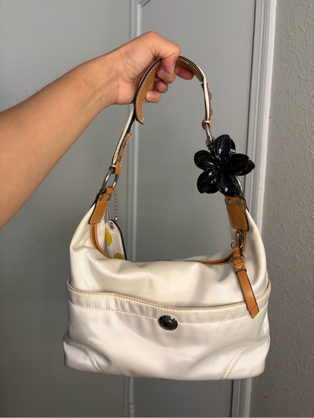 Coach Cream Shoulder Bag with Tan Accents and Black Flower Charm